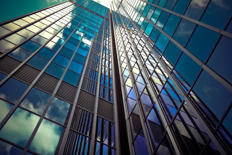 Skyscraper against blue sky and clouds